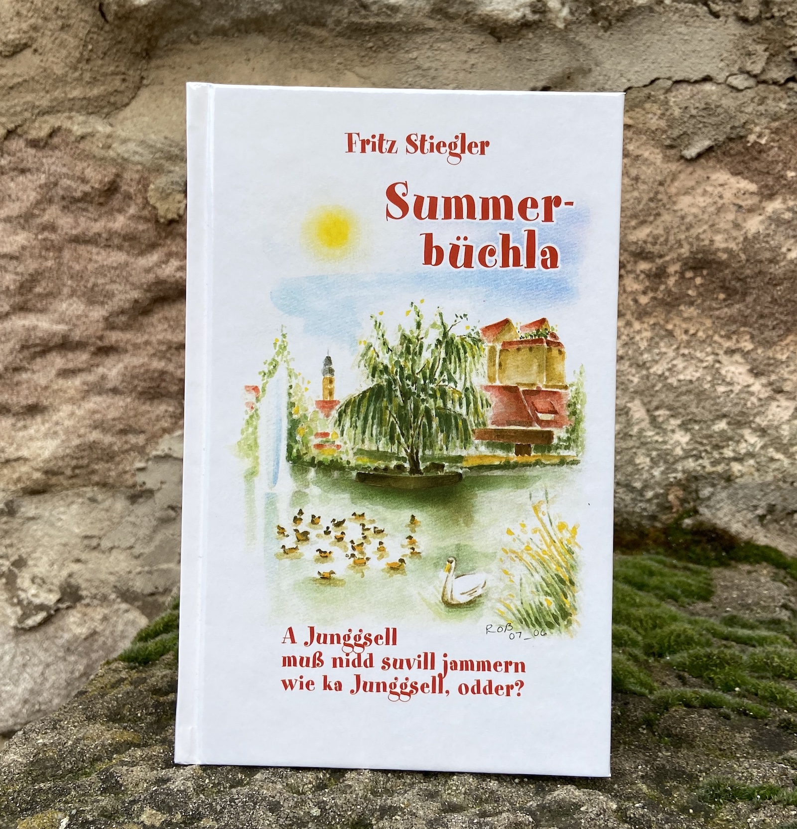 Das fränkische Summerbüchla zeigt ein liebevoll illustriertes Buch mit idyllischer Parkszene und Aquarellmotiven. Das fränkische Summerbüchla zeigt ein liebevoll illustriertes Buch mit idyllischer Parkszene und Aquarellmotiven.